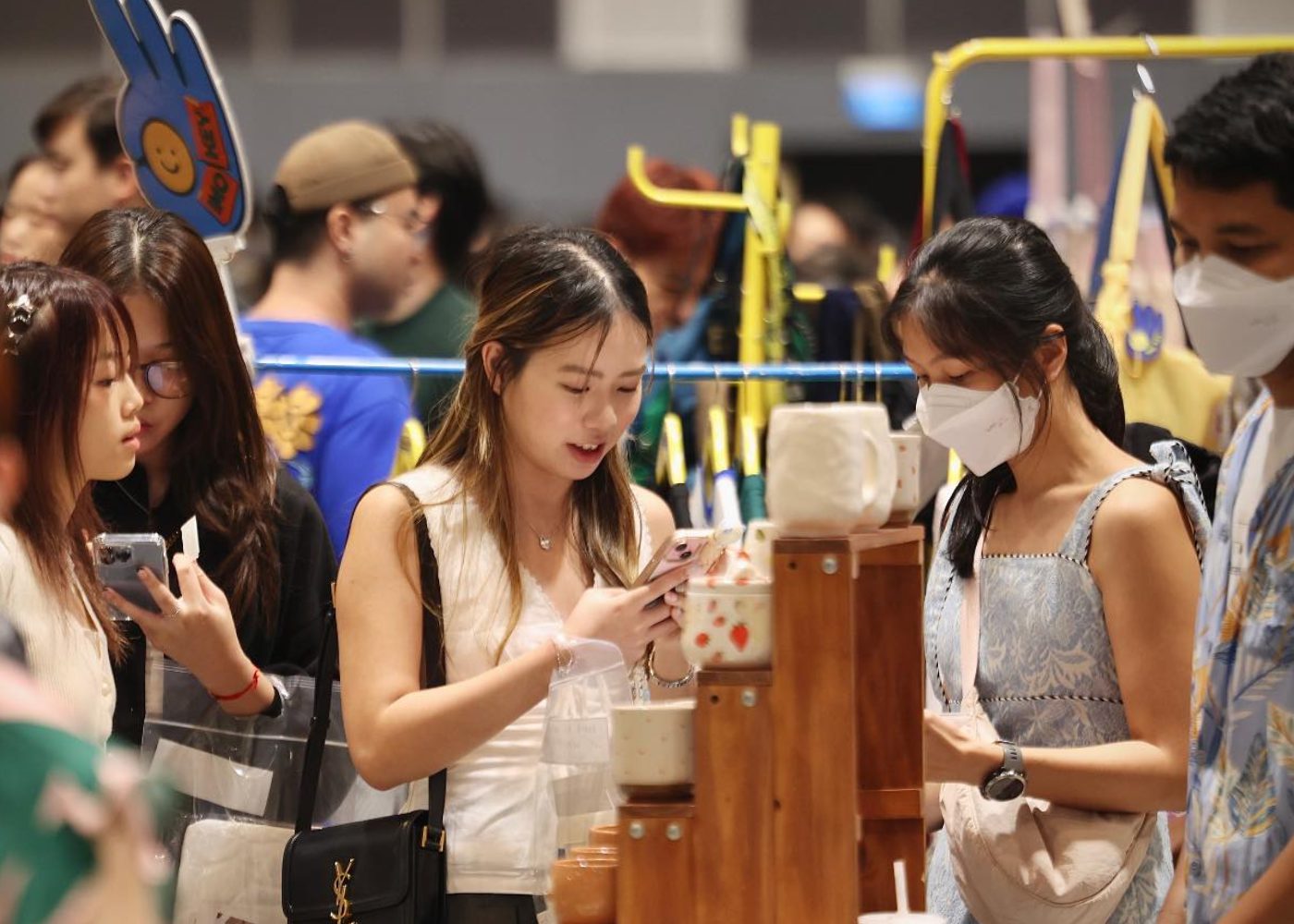 Shoppers browsing indie designer and maker booths at Public Garden art market, Suntec Singapore