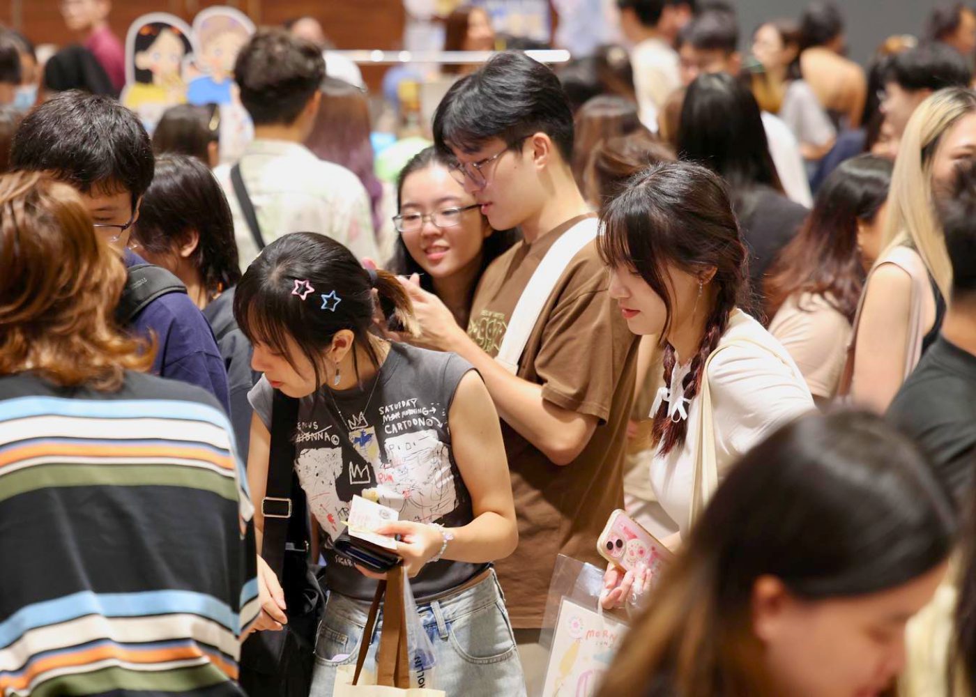 Dense crowd of visitors filling the aisles at Public Garden market in Suntec Convention Hall